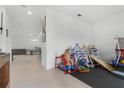 A play room with tile flooring, next to a dining area and living space, perfect for Gathering time at 2877 Fitness St, Clermont, FL 34714
