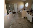 Bathroom features a combination tub and shower, window, tile flooring, toilet, and sink with vanity at 3171 Santa Cruz Dr, Kissimmee, FL 34746
