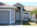 Inviting front door with well-manicured lawn and garden, featuring a charming single-story home at 3171 Santa Cruz Dr, Kissimmee, FL 34746