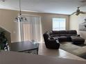 Open floor plan with a comfortable seating area, adjacent to a dining space with modern furniture at 3561 Sanctuary Dr, St Cloud, FL 34769