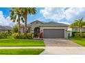 Beautiful single-story home boasts a well-kept lawn, attractive landscaping, and a convenient two-car garage at 4007 Green Sabal Dr, Orlando, FL 32824