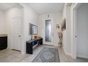 Bright foyer with neutral tile flooring, a decorative rug, and a glass-paneled front door at 4007 Green Sabal Dr, Orlando, FL 32824