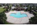 Community pool area with ample seating, lush landscaping, and a shaded structure for gatherings and relaxation at 4007 Green Sabal Dr, Orlando, FL 32824