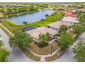 Aerial view of home with view of the pond, trees, and surrounding neighborhood at 4125 Navigator Way, Kissimmee, FL 34746