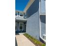 Side view of a light blue townhouse with well-maintained landscaping and visible window details at 4525 Sw 52Nd Cir # 103, Ocala, FL 34474