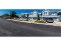 Street view of light blue townhouses with well-kept lawns and parked cars at 4525 Sw 52Nd Cir # 103, Ocala, FL 34474