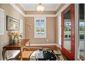 Welcoming foyer features a red front door, hardwood floors, and a decorative rug at 4561 Henry J Ave, St Cloud, FL 34772