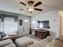 Comfortable living room with sectional sofa, mounted TV, and decorative accents at 4765 Lake Shore Dr, St Cloud, FL 34772