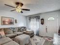 Cozy living room with plush sectional sofa, decorative rug, and natural light from the front door at 4765 Lake Shore Dr, St Cloud, FL 34772