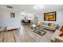 Spacious living room leading to dining area with hardwood floors, modern furniture, and stylish decor at 5123 Lighthouse Rd, Orlando, FL 32808
