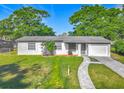Charming single-story home with a well-manicured lawn and inviting curb appeal under a bright blue sky at 514 S Cottage Hill Rd, Orlando, FL 32805