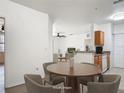 Cozy dining area with a round table and four chairs, adjacent to the living room at 5550 E Michigan St # 2214, Orlando, FL 32822