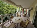 Spacious balcony is furnished with a table and chairs, great for enjoying the outdoors at 7658 Whisper Way # 203, Reunion, FL 34747