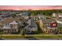 Expansive aerial view of a neighborhood showcasing the home's location among lush greenery and other residences at 8338 Modiano St, Orlando, FL 32827
