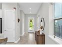 Bright entryway with hardwood floors, elegant decor, and a clear view to the front door at 8338 Modiano St, Orlando, FL 32827