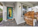 Cozy front porch showcasing an inviting entryway, stylish furniture, and lush landscaping at 8338 Modiano St, Orlando, FL 32827