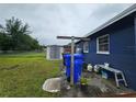 Fully-fenced backyard features a storage shed, lawn, clothesline, and blue painted home exterior at 1617 Emmett St, Kissimmee, FL 34741