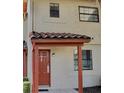 Charming townhome exterior featuring an arched doorway, tiled roof, and neutral stucco at 10330 Turkey Lake Rd # A-4 Ak/A 107, Orlando, FL 32819