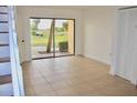 Inviting living room with tile flooring, natural light, and a sliding glass door to an outdoor space at 10330 Turkey Lake Rd # A-4 Ak/A 107, Orlando, FL 32819