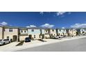 View of townhouses featuring a well-maintained front yard and neutral color palette at 4871 Coral Castle Dr, Kissimmee, FL 34746