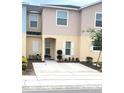 Charming townhouse featuring a well-maintained front yard and neutral color palette at 4871 Coral Castle Dr, Kissimmee, FL 34746