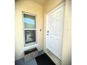 Close up view of front door with Ring Doorbell and a front window at 4871 Coral Castle Dr, Kissimmee, FL 34746