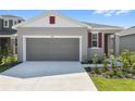 Charming one-story home with a two-car garage, landscaped yard and neutral exterior at 6385 Clover St, Lake Hamilton, FL 33851