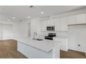 Open kitchen with quartz countertops, stainless steel appliances, and ample cabinet space at 6385 Clover St, Lake Hamilton, FL 33851