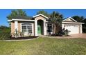 Charming single-story home with a well-manicured lawn and attached two car garage at 738 Leonardo Ct, Kissimmee, FL 34758