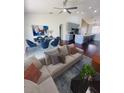 Bright open-concept living room featuring a modern kitchen, dining area, and comfortable seating at 738 Leonardo Ct, Kissimmee, FL 34758