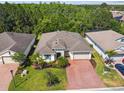 Aerial view of home showing mature landscaping and paver driveway at 789 Cielo Trl, Kissimmee, FL 34759