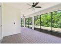 Enjoy outdoor living on this screened patio with brick flooring, ceiling fans, and views of the natural surroundings at 789 Cielo Trl, Kissimmee, FL 34759