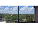Enjoy the lush views of the surrounding greenery and blue skies from this comfortable screened in outdoor living space at 8296 Portofino Dr # 401, Davenport, FL 33896