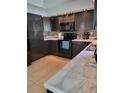 The kitchen has black appliances, light countertops, and decorative backsplash at 13 Dorset Dr, Kissimmee, FL 34758