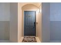 Inviting entryway with a charming welcome mat, light, and a secure, stylish door at 3301 Whitestone Cir # 203, Kissimmee, FL 34741