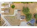 An aerial view of the home shows the roof, garage, long driveway, and neighborhood surroundings at 7938 Riffle Ln, Orlando, FL 32818