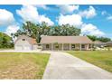 Charming single-story home with an attached two-car garage and a long driveway and well-maintained lawn at 7938 Riffle Ln, Orlando, FL 32818