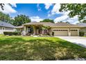 Charming single-story house featuring a three-car garage and well-maintained landscaping for curb appeal at 9509 Baycliff Ct, Orlando, FL 32836