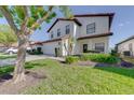 Inviting home with lush green lawn, a convenient two-car garage, and a welcoming facade at 141 Summer Place Loop, Clermont, FL 34714