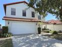 Lovely house with two car garage, tile roof, a well manicured yard and inviting entrance at 141 Summer Place Loop, Clermont, FL 34714