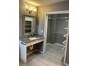 Bathroom featuring a granite vanity and walk-in closet with built-in shelving at 1512 Ison Ln, Ocoee, FL 34761
