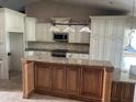 Modern kitchen with a granite island, stainless steel appliances, and ample cabinetry at 1512 Ison Ln, Ocoee, FL 34761