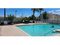 Inviting community pool and lounge area with clear blue water and comfortable seating under a sunny sky at 2804 Club Cortile Cir # A, Kissimmee, FL 34746