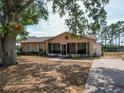 Charming single-story home with a screen porch, mature landscaping, and a spacious front yard at 629 N 7Th St, Lake Wales, FL 33853