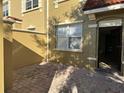 Private courtyard entrance featuring a brick paver patio and stucco privacy wall at 2550 Bella Vista Dr, Davenport, FL 33897