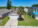 Well-maintained home with a lush front yard, two-car garage, and mature landscaping, showing curb appeal at 14131 Ridge Creek Ct, Orlando, FL 32824