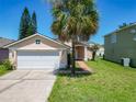 Single-Gathering home with a two-car garage, a well-manicured lawn, and mature trees in a suburban setting at 14131 Ridge Creek Ct, Orlando, FL 32824