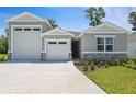 Charming single-Gathering home with a well-maintained lawn and a three car garage at 317 Alexandrite St, Deland, FL 32720