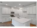 Bright kitchen with white cabinets, stainless steel appliances, and a large center island at 317 Alexandrite St, Deland, FL 32720