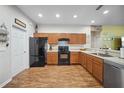 Well-equipped kitchen featuring wood cabinets, laminate floors, and modern appliances at 3633 Bristol Cove Ln, St Cloud, FL 34772